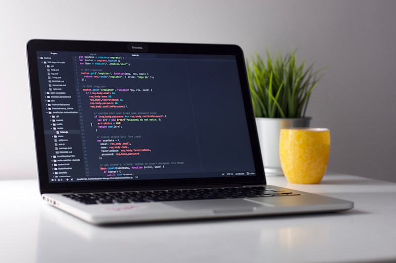 Developer working on laptop with code editor