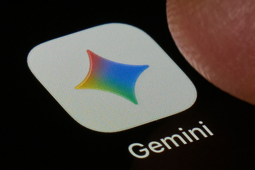 Gemini app icon close-up photo showing colorful four-pointed star on smartphone screen
