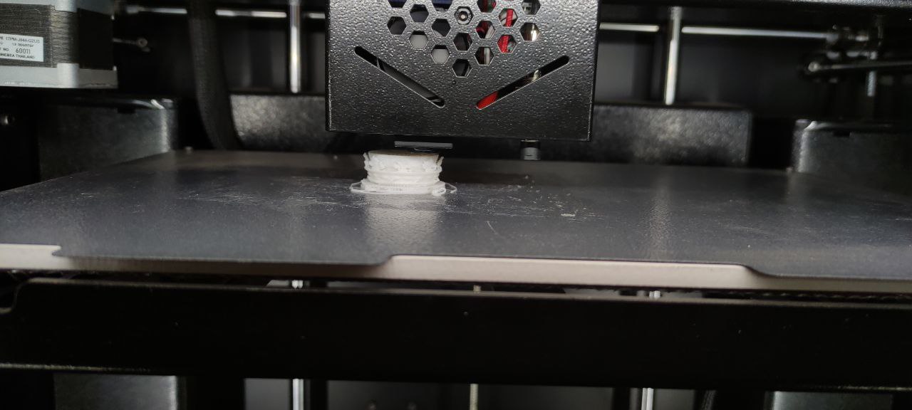 Máy in 3D Prusa i3 đang in vật thể nhựa màu xanh