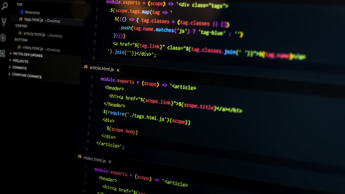 Developer writing Rust code on desktop computer with dual monitors