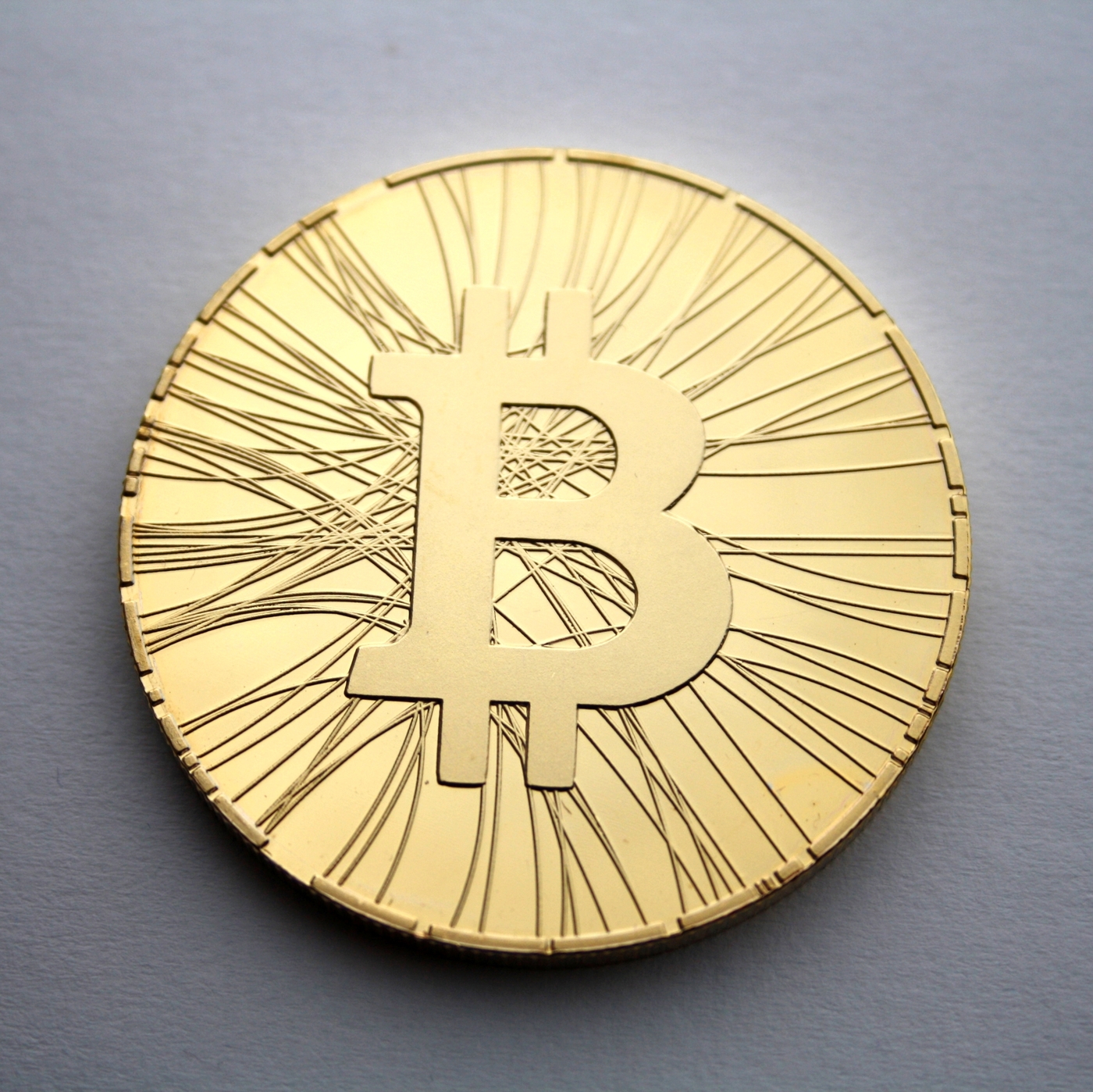 Mặt thiêng của đồng Bitcoin vật lý với hình chữ B khắc nổi